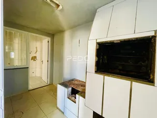 Interior de uma sala com passagem para um ambiente adjacente.