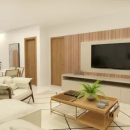 Sala de estar moderna com sofá e televisão de parede em um ambiente claro.