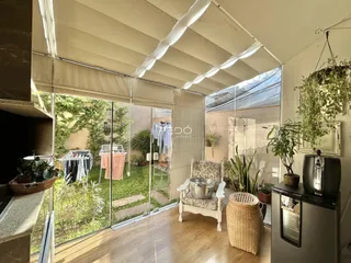 Sala de estar com portas de vidro que dão acesso a um jardim.