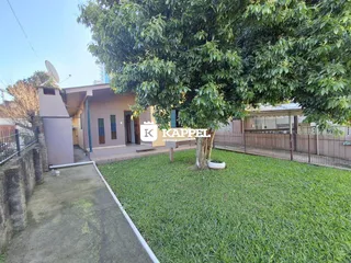 Foto da fachada de uma residência em Lajeado, Brasil, com um jardim gramado.