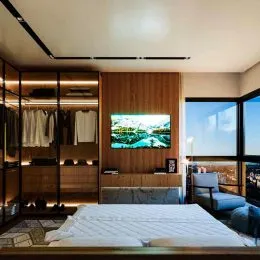 Quarto com cama grande e painel de madeira.