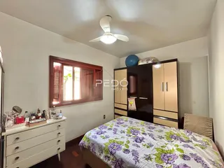 Quarto com janela e guarda-roupa de madeira em Lajeado.