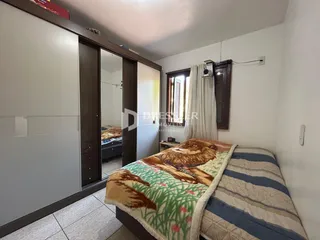 Quarto com armário de madeira e cama decorada.