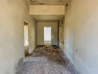 A foto mostra um corredor interno de uma propriedade em construção.