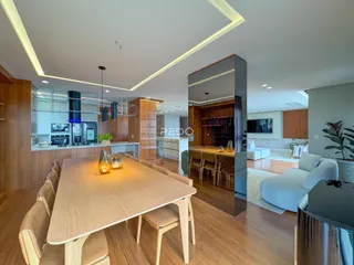 Vista de uma sala de jantar e cozinha moderna em um imóvel.