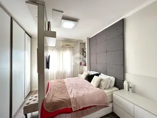 Quarto com cama e armários em um apartamento.