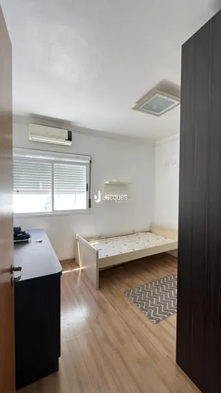 Quarto com cama e janela em ambiente interno.