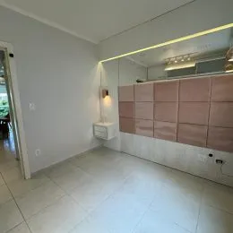 Ambiente interno com paredes brancas e piso de cerâmica.