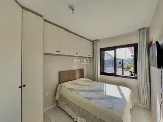 Quarto com armários embutidos e janela de boa iluminação.