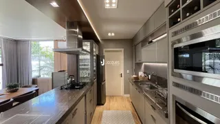 Vista da cozinha moderna com armários e eletrodomésticos de aço inoxidável.