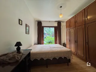 Quarto com cama e painéis de madeira na parede.