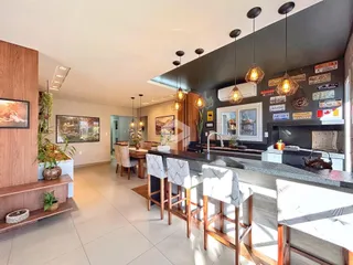 Interior de uma cozinha moderna com balcão e área de jantar em Lajeado.