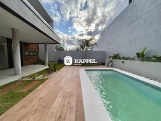 Uma foto de uma piscina externa em um imóvel moderno com deck de madeira.