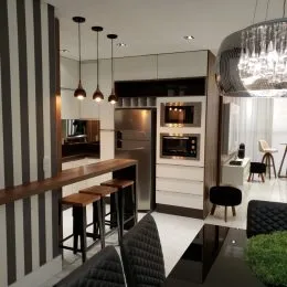 Cozinha moderna com armários e eletrodomésticos de aço inoxidável.