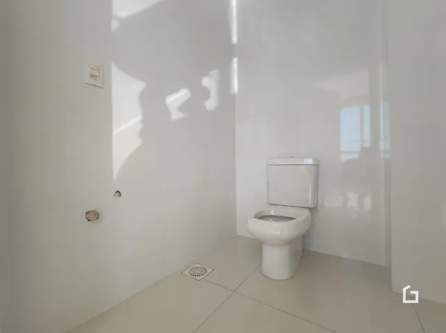 Foto de um ambiente interno mostrando um vaso sanitário branco.