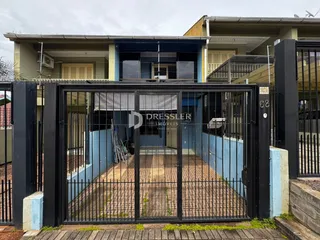 Foto da entrada de uma residência em Lajeado, Brasil, mostrando o portão de ferro preto.