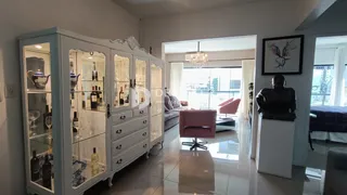 Um corredor interno com armários brancos e uma porta de entrada para outra sala.