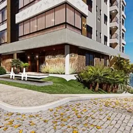 Fachada moderna de um edifício residencial em Lajeado, Brasil, com paisagismo na frente.