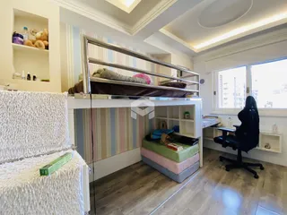 Quarto com estrutura de cama e estantes em um ambiente claro.