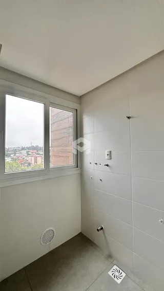 Parede interna com janela e piso claro em um imóvel.