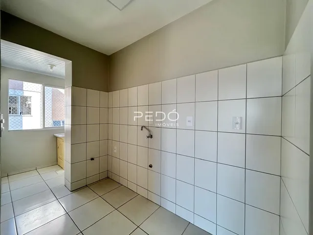 Corredor interno com revestimento cerâmico nas paredes e piso.
