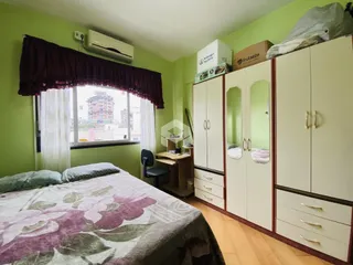 Quarto com armários embutidos e vista para a paisagem urbana.