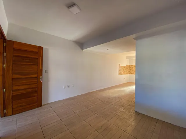 Hall de entrada com piso de cerâmica e paredes brancas.