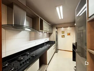 Foto de uma cozinha moderna com armários e bancadas escuras.