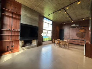 Ambiente amplo com paredes de tijolo e piso de porcelanato em uma residência.