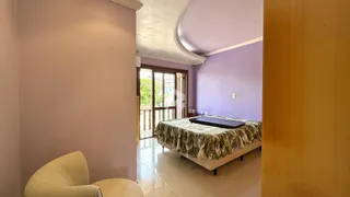 Quarto com paredes roxas e porta de madeira visível na imagem.