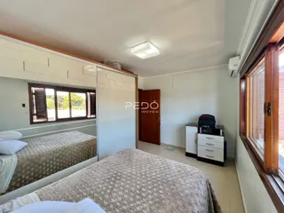Quarto com cama e armário em ambiente claro.