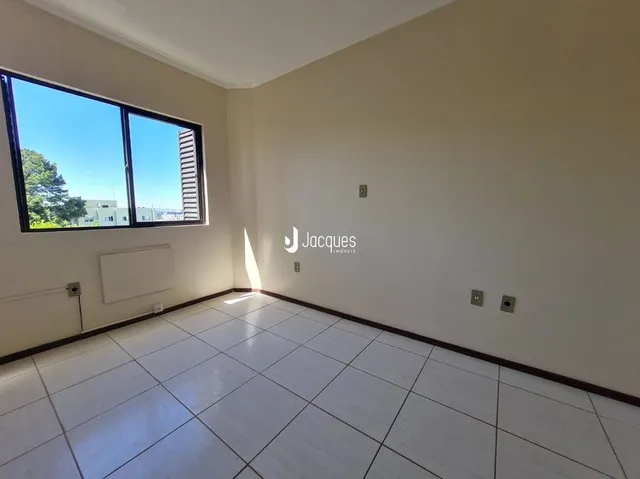 Sala de estar com piso de cerâmica e grande janela.