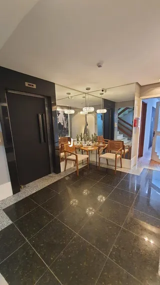 Ambiente interno com piso de cerâmica escura e mesa de jantar.