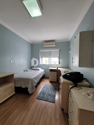 Quarto com piso de madeira e armário embutido.