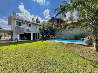 Fachada de casa com jardim e piscina em Lajeado.
