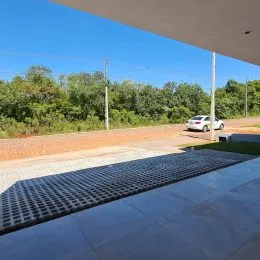 Área externa pavimentada com piso escuro em uma propriedade em Lajeado.