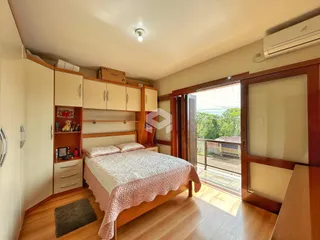 Quarto com armários e cama de madeira em um imóvel no Brasil.