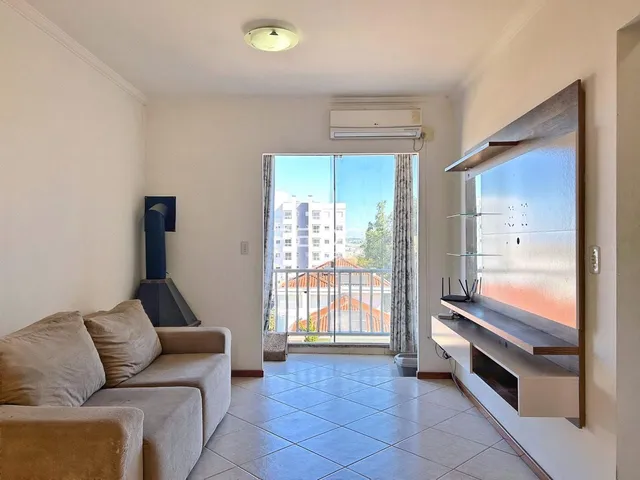 Sala de estar com piso de cerâmica e vista para o exterior.
