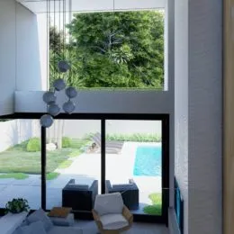 Vista da sala de estar com grandes janelas que dão para a vegetação externa.