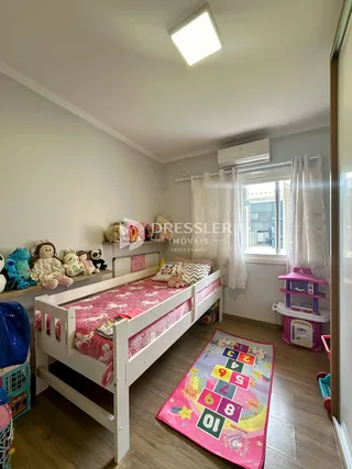 Quarto com cama e janela em ambiente residencial.