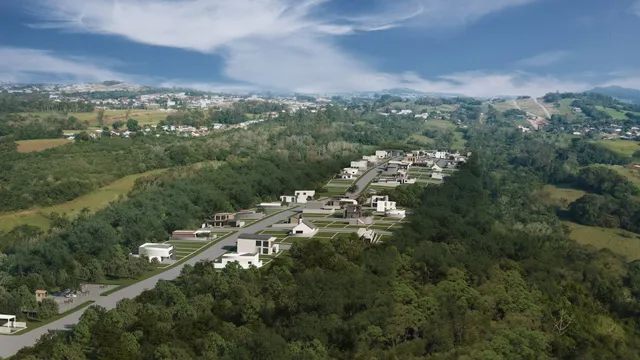 Vista aérea de um loteamento residencial em Lajeado, Brasil, com casas em meio à vegetação.