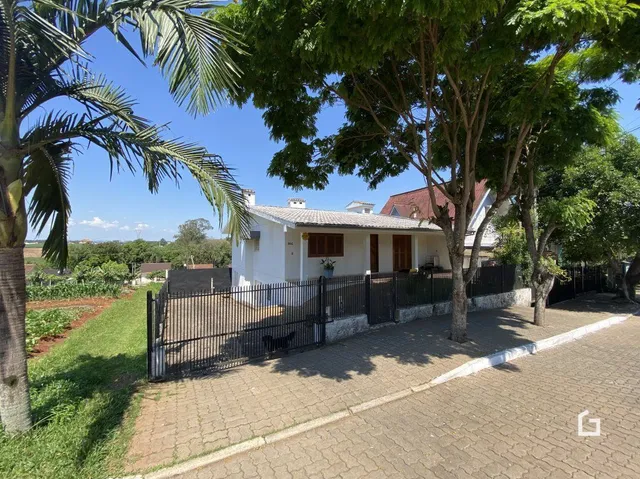 Fachada de uma casa em Lajeado, Brasil com cerca e jardim na frente.