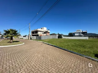 Vista externa de uma propriedade em Lajeado, Brasil, com área gramada e edificações ao fundo.