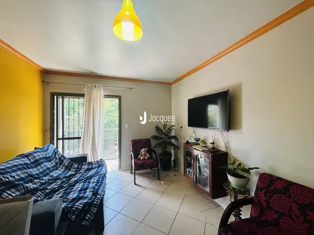 Sala de estar com parede amarela e vista para o exterior.