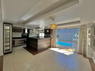 Sala de estar com vista para a área externa e piscina.