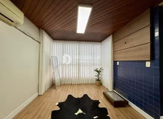 Sala de estar com piso de madeira e teto de madeira.