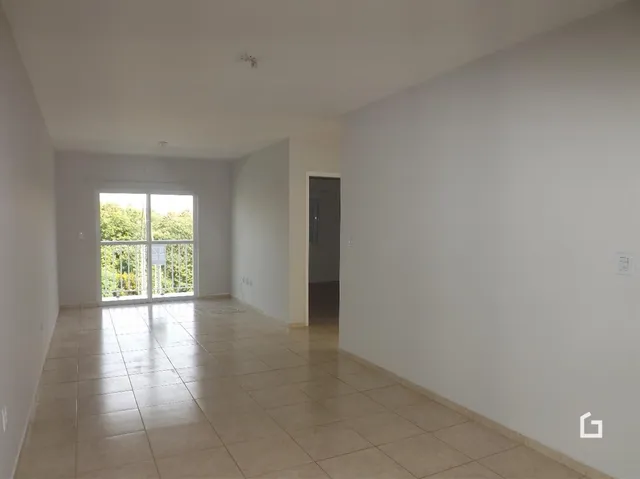 Sala de estar com piso de cerâmica e grande janela.