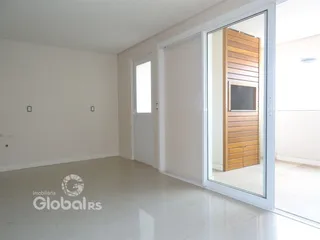 Interior de uma sala com paredes brancas e piso claro.