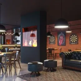 Foto interna de uma sala de estar com sofá e decoração moderna.