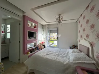 Quarto com cabeceira e decoração rosa em um imóvel no Brasil.